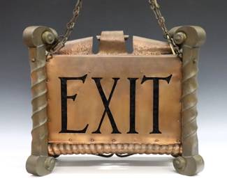 An early 20th century American Arts & Crafts Period hanging theater sign.  Hammered Copper body with scrolled detail, reads "Aisle 4" at front with Cobalt Blue glass insert, and "Exit" on the reverse with Ruby glass insert.  Some wear to patina.  19 x 9 1/2 x 15 1/2" high overall.