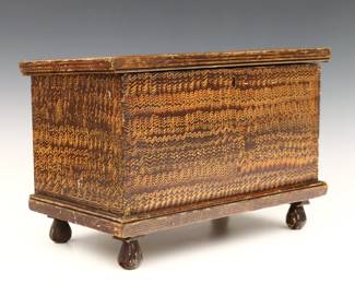 A late 19th century American miniature blanket box.  Dovetailed Pine construction with a hinged molded rim and original Brown grain painted finish.  Some wear, old replaced hinges and area with in-painting at top. 14 1/2 x 8 x 9 1/2" high overall.