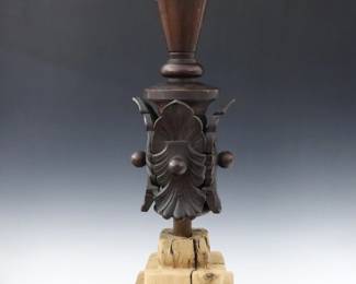 A 19th century American carved architectural finial.  Turned and carved wooden finial on a rough wooden plinth with stepped design.  Original dark finish with some wear and flakes, plinth with shrinkage.  28" high.  NOTE: From the Collection of Connie Covent, "Sign of the Windsor Chair" Antiques, Clarkston, Michigan.