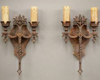 A pair of early 20th century Gothic Revival Period sconces.  Cast Aluminum bodies with Dragon design, double arms and patinated finish.  Wear and oxidation to finish, some paint splatters, discoloration to "candles".  Each 14 1/2" high.