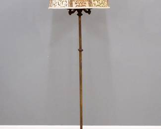 An early 20th century Gothic Revival Period floor lamp by Rembrandt Lamp Company.  Cast Iron construction with three lights on a simple squared stem and cast foot with four feet, includes a later "damask" printed shade.  Cast "Pat Applied for Rembrandt" at underside.  Wear to patina.  68" high.