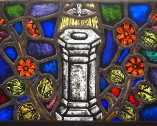 A Gothic Revival Stained Glass panel.  Multi-color stained and leaded glass panels in a with reverse painted details depicting a Dove descending on a Baptismal font.  Panels intact with minor flakes to some edges, some wear to paint.  13 x 8 1/2" high overall.