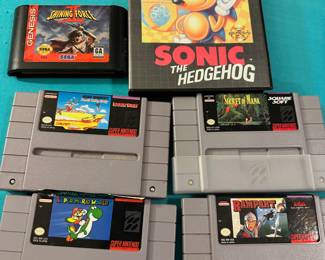 Sega Genesis Shining Force and Sonic the Hedgehog, Super Nintendo Secret of Mana, Super Mario World, Rampart and Road Runners Death Valley Rally