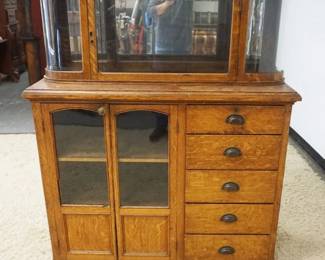 1216	2 PART OAK COUNTRY STORE CABINET W/5 DRAWERS & CURVED GLASS DISPLAY CASE TOP, APPROXIMATELY 28 IN X 19 IN X 56 IN HIGH
