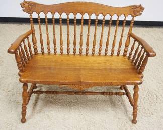 1207	SOLID OAK TURNED SPINDLE BACK BENCH W/CARVED LIONS ON CREST
