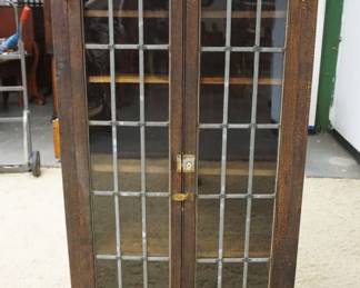 1215	WALNUT BOOKCASE W/DOUBLE LEADED GLASS DOORS & ADJUSTABLE INTERIOR SHELVES, APPROXIMATELY 34 IN X 18 IN X 60 IN HIGH, ALLIGATOR FINISH
