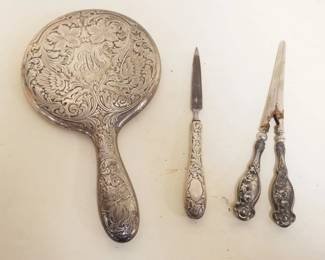 1045	SILVER DRESSER SET W/MIRROR, CURLING IRON & NAIL FILE, MIRROR APPROXIMTELY 10 IN
