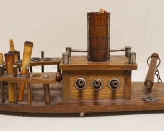 1067	FOLK ART OAK TABLE TOP SMOKING STAND IN THE FORM OF A GUN BOAT, SOME LOSS, APPROXIMATELY 20 IN X 6 IN X 7 IN HIGH
