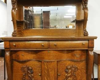 1175	HEAVILY CARVED OAK MIRROR BACK SIDEBOARD W/CHERUBS & PAW FEET, APPROXIMATELY 54 IN X 25 IN X 81 IN HIGH
