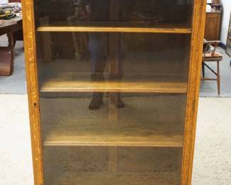 1219	SOLID OAK NORTHWIND CARVED ONE DOOR BOOKCASE W/ADJUSTABLE SHELVES & CLAW FOOT FRONT LEGS, APPROXIMATELY 35 IN X 15 IN X 57 IN HIGH
