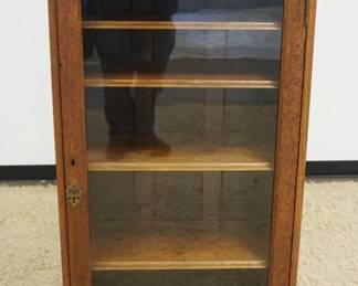 1222	SOLID OAK NARROW ONE DOOR BOOKCASE W/ADJUSTABLE SHELVES, APPROXIMATELY 26 IN X 12 IN X 55 IN HIGH
