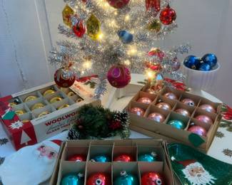 Vintage Christmas decorations, including Shiny Brite glass ornaments, satin bulbs, and plastic reflectors. 