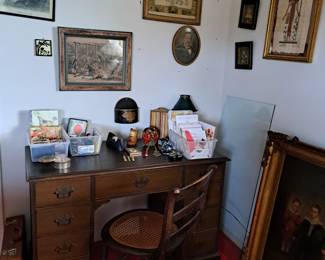 KNEE HOLE DESK WITH GLASS TOP ON THE SIDE, DESK SUPPLIES, GREETING CARDS, FRAMED DOCUMENTS AND PHOTOS