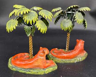 Pair ceramic lioness with metal palmtree candleholders $150