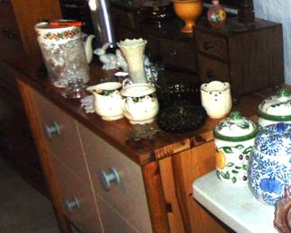 Ceramics, porcelain, and glassware on a storage unit (items sold separately).