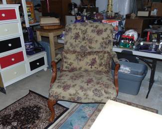 Upholstered armchair, rugs, and other items (items sold separately).