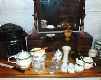 Ceramics, porcelain, and glassware, and vintage dresser with mirror (items sold separately).