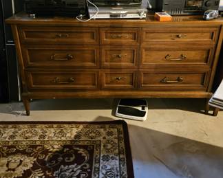Mid Century 9-drawer chest, rug, and audio equipment (items sold separately).
