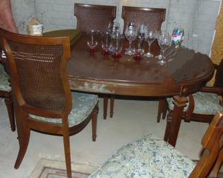 Oval Dining room table and 6 cane backed chairs, and glassware (glassware sold separately).