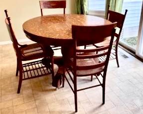 Beautiful quarter sawn oak heavy and sturdy pedestal table with 4 carved oak caned seat chairs.   47-1/2” d with 2 additional leaves 8”w.   $400 / 5 pc set.  