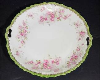 Lot 194   0 Bid(s)
Pretty Vintage marked double handled floral themed green scalloped edge plate