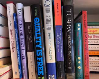 Group of books including Quality is Free