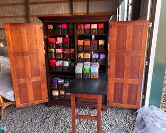 Craft Cabinet with drop down desk. Collection of vintage/antique sewing machine drawers filled with fabric packets.