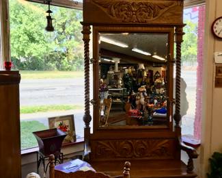This beautiful oak carved Hall tree with barley twist sides and storage drawer and place for shoes needs a good home. Approximately 7' Tall.  Beveled mirror. We are going to miss it when its gone.  One of a kind.