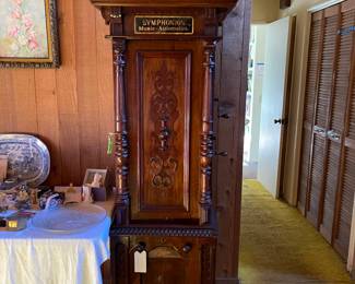 Symphonion Music Automaton - with drawer discs - very very rare . A very fine walnut case with walnut veneers and applied carvings, great original finish with warm mellow patina. The duplex comb movement arranged in sublime harmonie with two 5.5 inch combs totaling 100 teeth, plays a 13 5/8 inch disc. Disc storage in the lower portion of the cabinet and a locking drawer just below the mechanism bed plate. Winds and plays wonderfully. This is a straight and right and fine box in original condition throughout. Measures 65.5 x 21 x 14 inches. Twelve (12) Symphonion discs will be included with this music box.  Coin operated. 