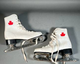 WOMEN’S WHITE CANADIAN ICE SKATES | Size 7 women’s white ice skates with Canadian maple leaf in ankle and maple leaf stamp on base. - l. 11 x w. 3 x h. 10 in