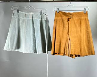 (2PC) LEATHER SKIRT & SHORTS | Including a light blue suede wrap skirt, size small (l. 16.5 in. x overall width 26 in.) and a pair of shorts in overall brown suede, zippered front; no apparent labels to either. 
