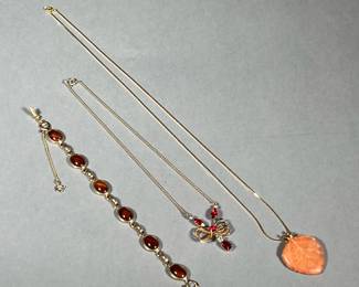 (3PC) GOLD-TONE JEWELRY | Including a Sarah Cov tiger's eye style bracelet, a resin leaf pendant on an unmarked gold chain, and a Scitarelli necklace with faux red gemstones on a bow-form pendant

