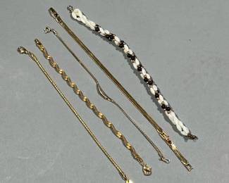 (5PC) GOLD-TONE BRACELETS | Costume jewelry bracelets, with nice gold appearance, including one with black and pearl-style beads, a twisted bracelet, an Avon bracelet with a faux diamond, an Avon bracelet with extension, and a bracelet stamped "S.H." on the clasp tag
