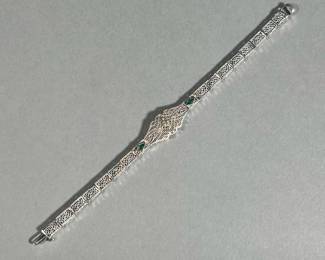 10K FILIGREE BRACELET | With central 0.10ct full-cut diamond flanked by two small mixed-cut emeralds; 5.3g. - l. 6.25 in

