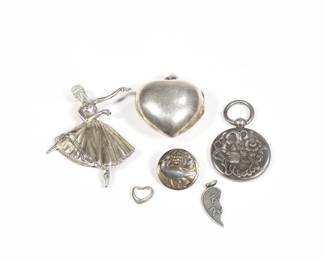 (6PC) STERLING PENDANTS & OTHER | Including a sterling silver heart-form locket pendant, a ballerina-form pin, a hollow art nouveau pendant, a Danish sterling pin with a bird, a broken heart charm, and a heart charm; all together 1.1 ozt
