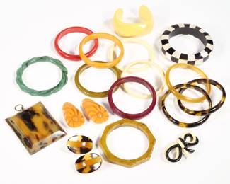BAKELITE COLLECTION | Bakelite and other jewelry, including 13 bracelets, a pair of orange clips, a double bow pin, a pair of earrings, and a small picture frame (3-1/28 x 2-1/2 in.)
