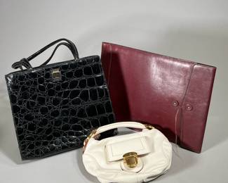 (3PC) LEATHER HANDBAS & CASE | Two vintage leather handbags, including a small white Marc Jacobs purse, suede-lined, and a black Furla handbag, fabric-lined, both made in Italy, as well as one sleek red full-grain hide document case by Bosca. Red Bosca: 10 x 14.5". Black Furla: 10 x 11", 4" base. White Marc Jacobs: 10 x 5", 3" base
