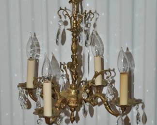 Antique Carved And Scrolled 4-Arm Chandelier Featuring Bronze Hardware and Crystal Drops Made in Spain, Sold "As Is" Because A few Crystal Drops are Missing 15" x 15", ($225). 