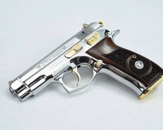 Make: CZ
Model: 75 SC Massada
Caliber: 9mm Para
Action: Semi
Barrel: 5
Bore: Shiny
Serial # A2774
Condition: Excellent
The CZ 75 is a semi-automatic pistol made by Czech firearm manufacturer CZUB. First introduced in 1975, it is one of the original "wonder nines" and features a staggered-column magazine, all-steel construction, and a hammer forged barrel. It is widely distributed throughout the world and is the most common handgun in the Czech Republic. This stunning model is adorn in nickel finish with gold tone accents. TThe pistol is sold with one magazine. 