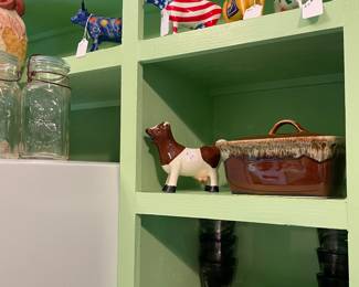 Top shelf around kitchen is a large “Cow Parade” cow collection