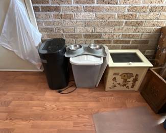 Shredder on left, dog bowls on mat + tub in middle & wastebasket with lid on right