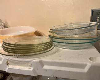 Plates, pie plates (some Pyrex) and orange Pyrex 