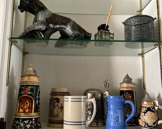 Steins, mugs, & decor - glass case in area off kitchen