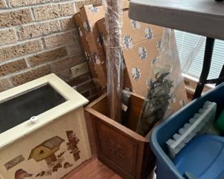 Boxes in corner, brown container with miscellaneous 