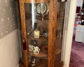 Antique glass front curio cabinet full of collectibles 