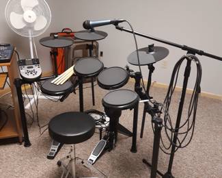 Electronic drum set by Alesis.  Microphone and stand are priced separately.  Not every drummer wants to be Phil or Don.