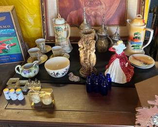 Painting of guy that may be “Albert Einstein” 
Misc tea sets 
Misc vintage salt shakers 
Raymond Enkeboll coffee table 