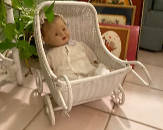antique doll in wicker pram