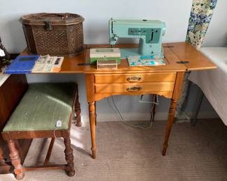 vintage turquoise Singer 337 with accessories in maple cabinet