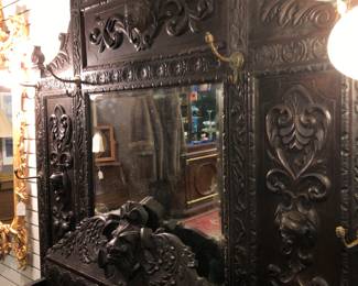 Large Victorian black oak hall tree with the top crest resting on the table top element. 